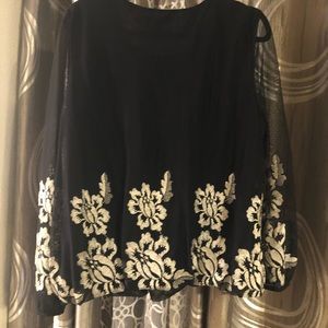 This is a dressy blouse with gold flowers, sheer sleeves and elastic waist.